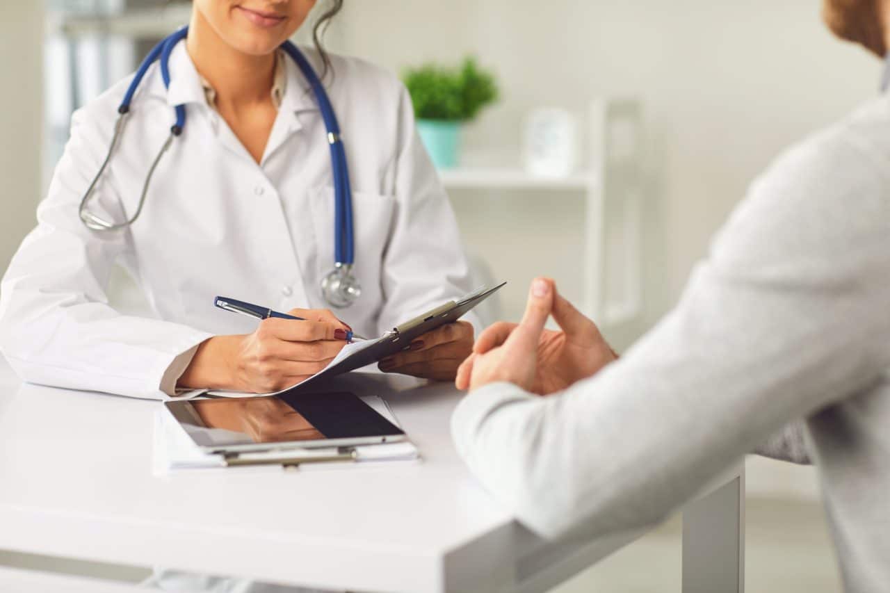 Doctor speaking with patient during consultation.