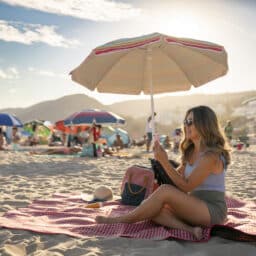 Woman under a beach umbrella on a hot day